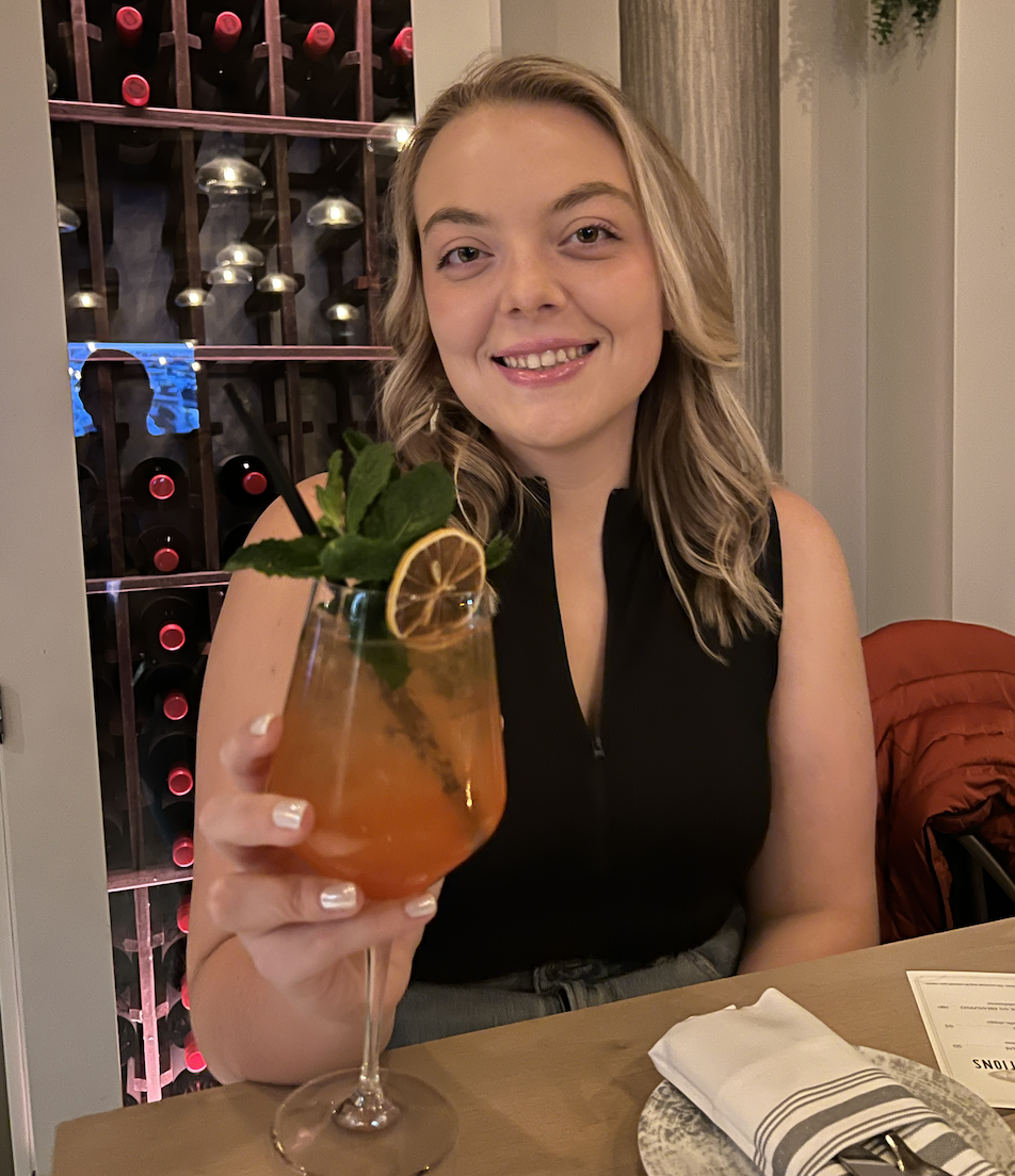 Photo of Abi holding a wine glass